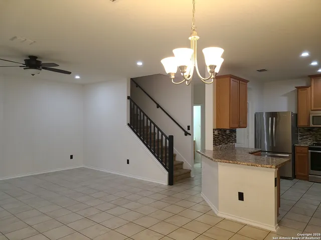 a view of a kitchen with a sink and refrigerator