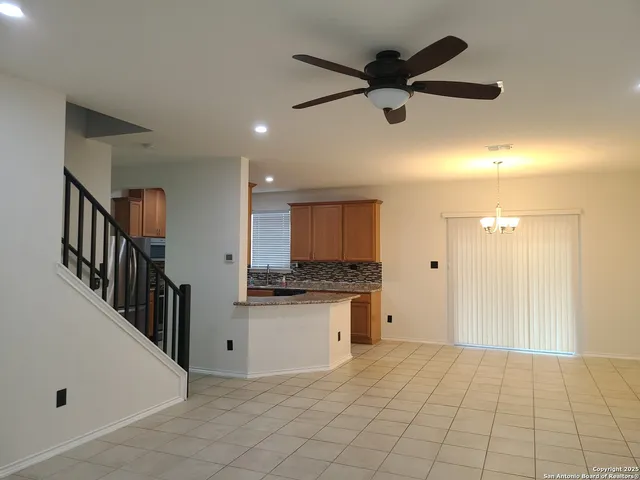 a view of a kitchen with a sink and a refrigerator