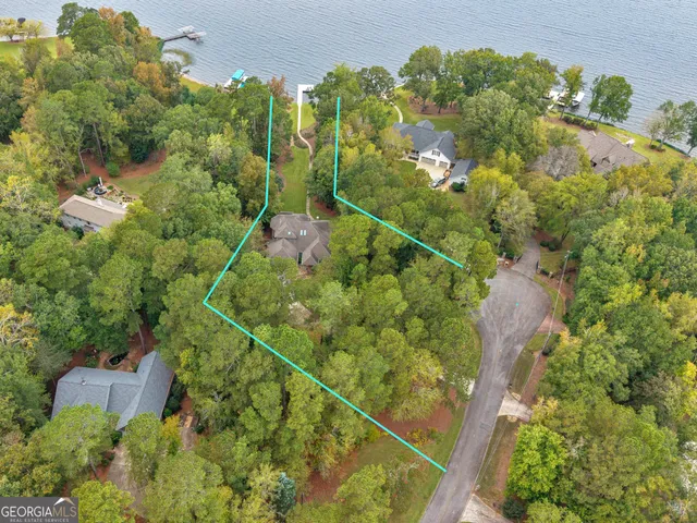 a kitchen with large windows and chairs