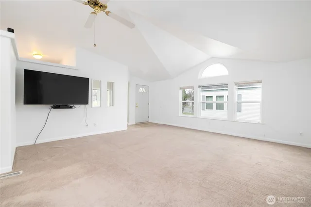 a view of livingroom with an empty room and flat screen tv