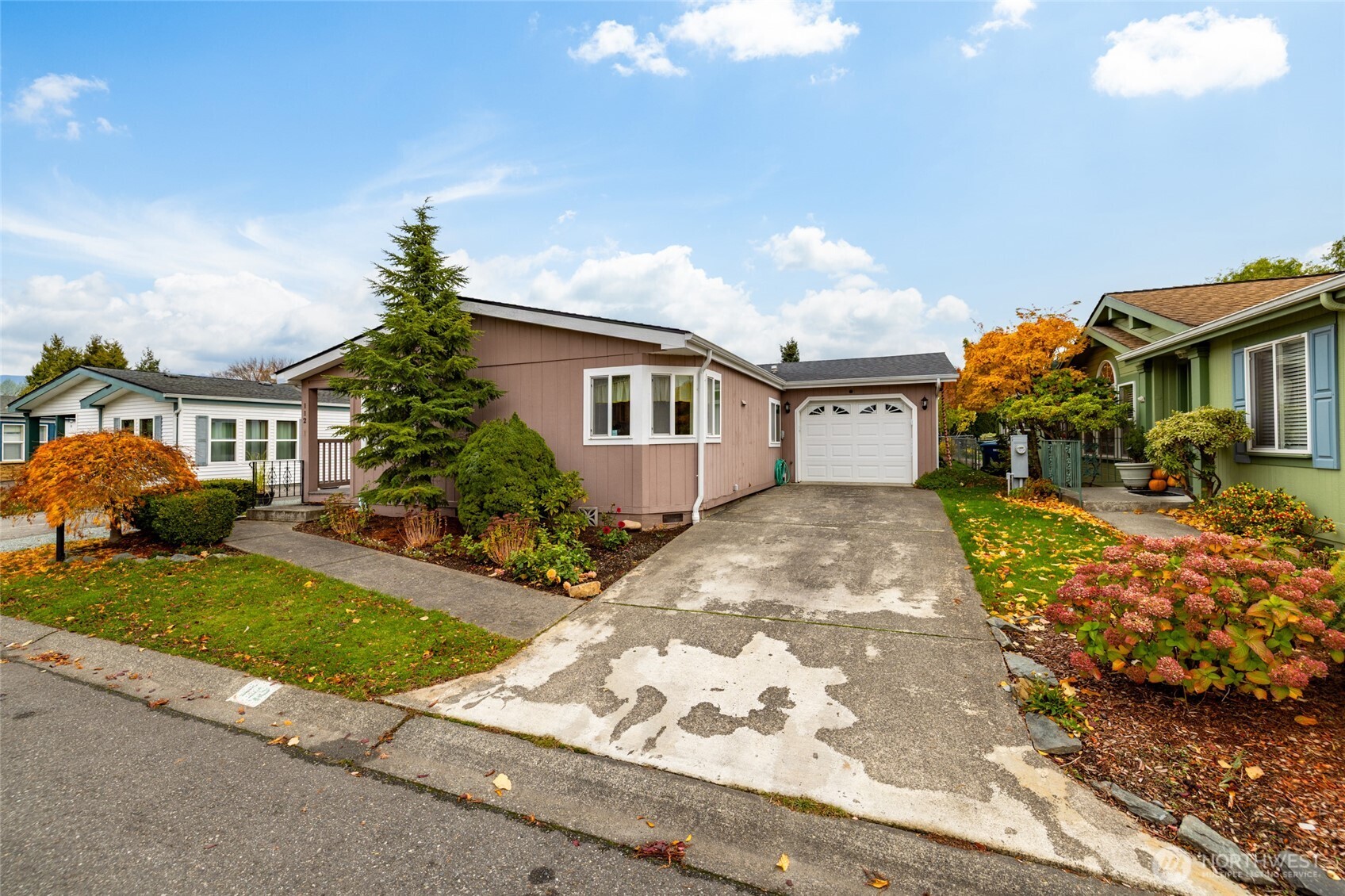 2610 East Section Street, Unit 112 Mount Vernon, WA 98274 - Photo 2 of 34 a front view of a house with garden