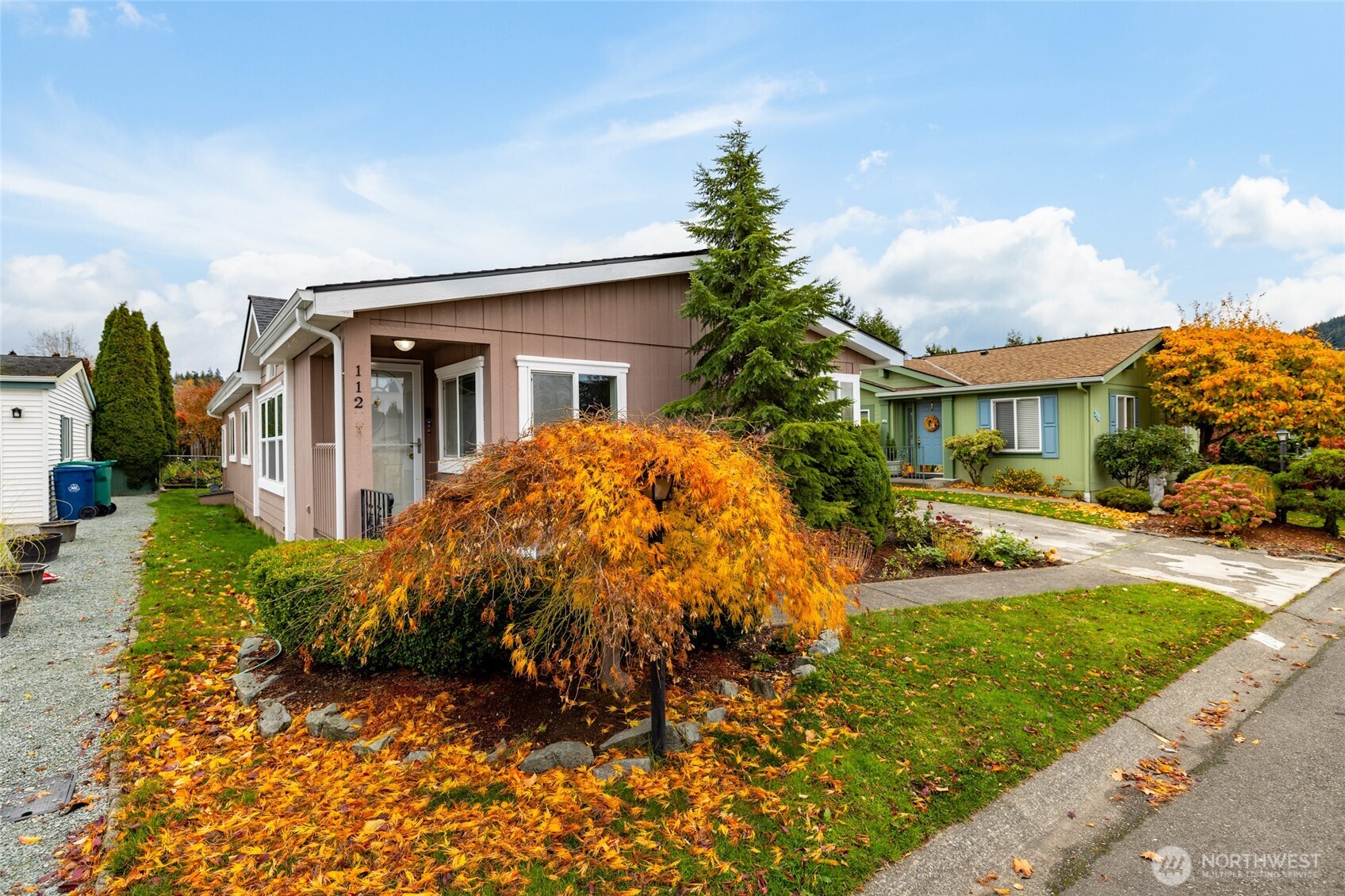 2610 East Section Street, Unit 112 Mount Vernon, WA 98274 - Photo 3 of 34 a front view of a house with garden