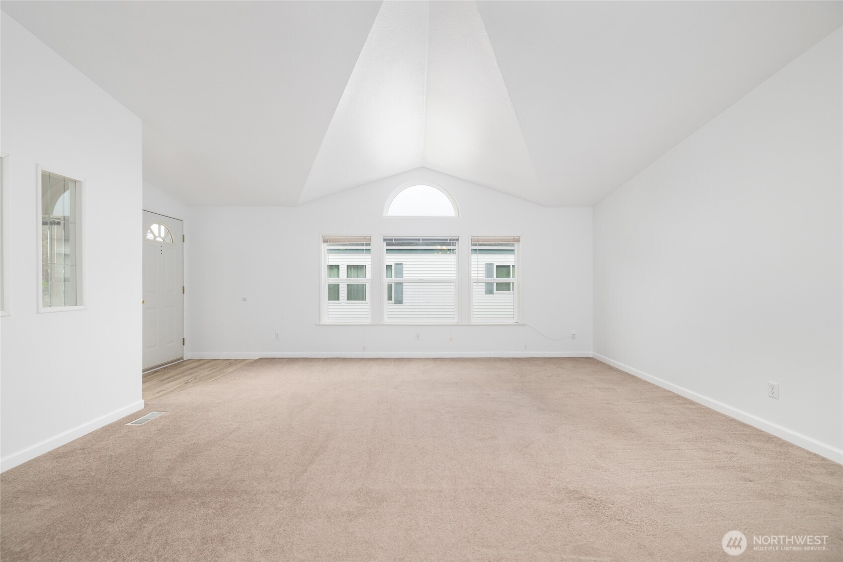 2610 East Section Street, Unit 112 Mount Vernon, WA 98274 - Photo 5 of 34 an empty room with windows and chandelier fan