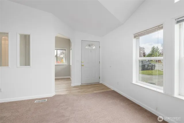 an empty room with windows and closet