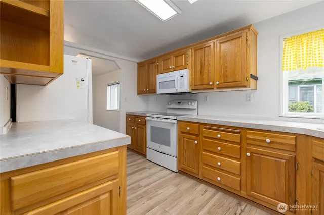 a kitchen with wooden cabinets and a stove top oven