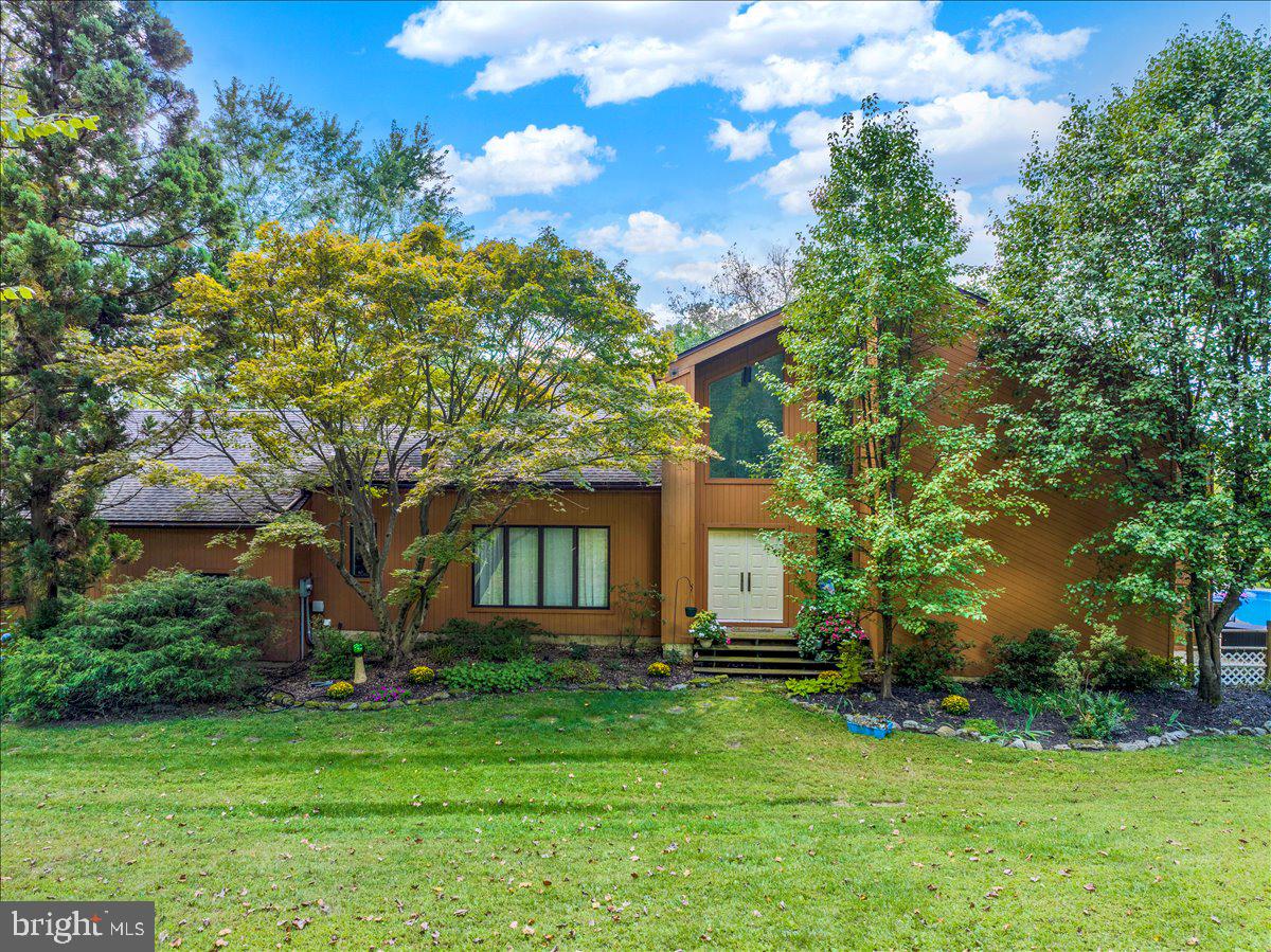 a front view of house with a garden