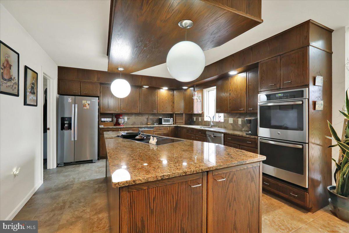 120 Deysher Road Fleetwood, PA 19522 - Photo 13 of 50 a kitchen with stainless steel appliances granite countertop a sink a refrigerator and a stove