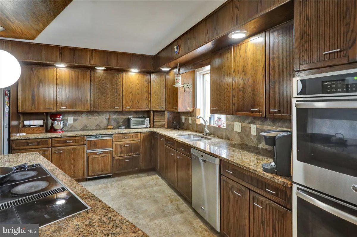 120 Deysher Road Fleetwood, PA 19522 - Photo 14 of 50 a kitchen with stainless steel appliances granite countertop a sink stove and cabinets