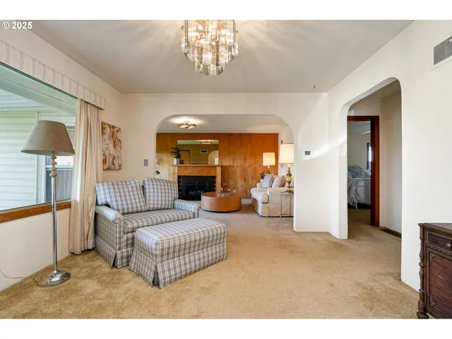 a living room with furniture and a lamp