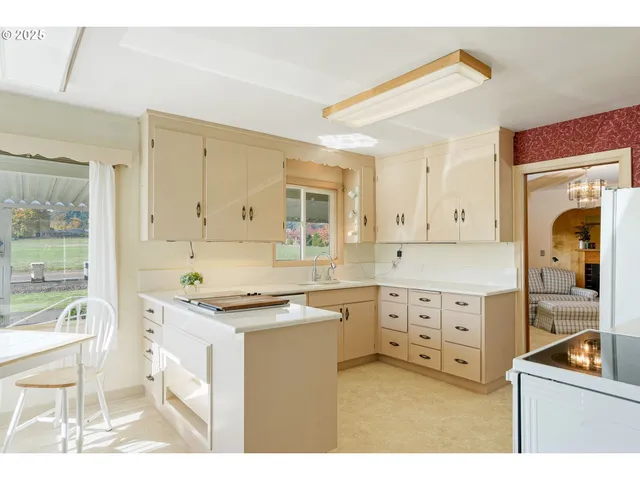 a kitchen with granite countertop a sink stove and cabinets