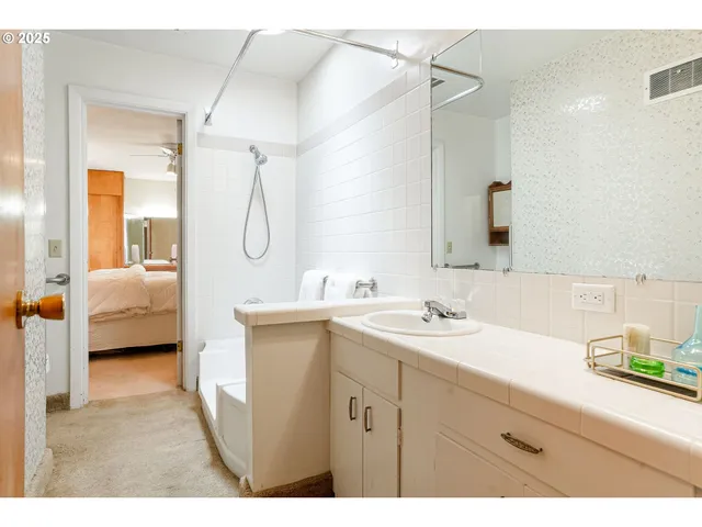 a en suite bathroom with a sink double vanity and a mirror