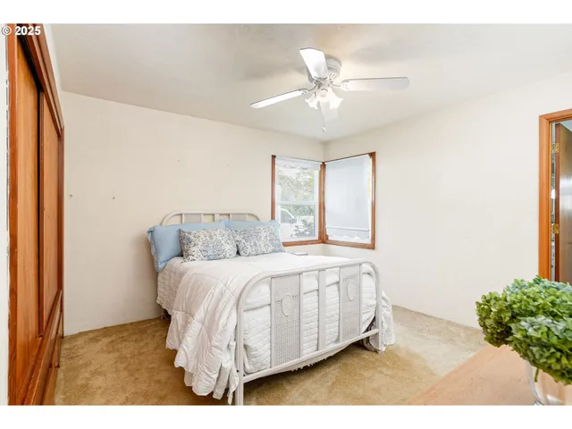 a bed sitting in a bedroom next to a window