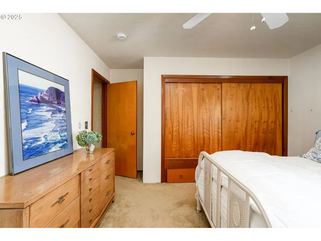 a bedroom with a bed and a dresser