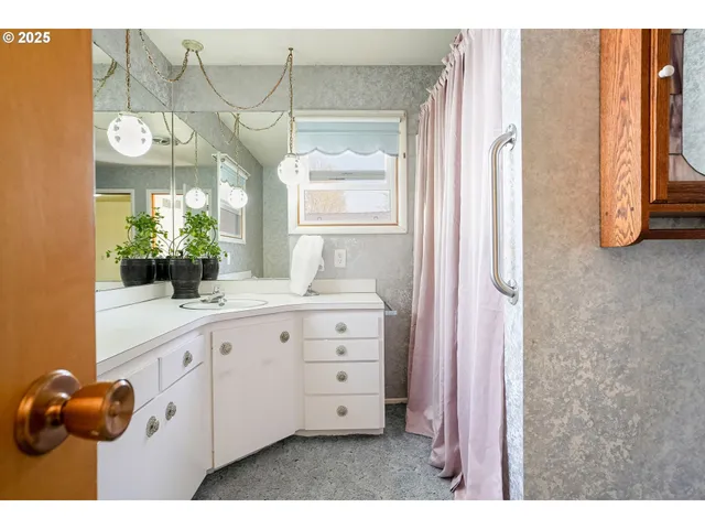 a bathroom with a sink and mirror