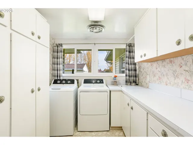 a view of washer and dryer with kitchen view