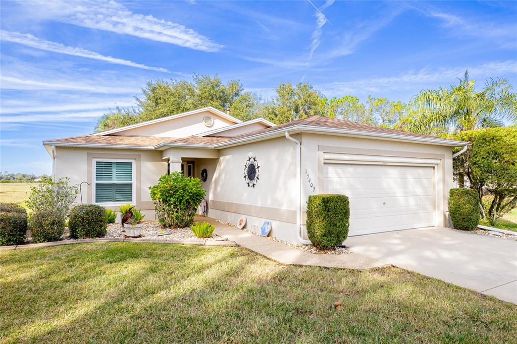 15402 Southwest 15th Terrace Road Ocala, FL 34473 - Photo 1 of 1 a front view of a house with garden