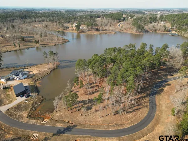 an aerial view of a house with a lake view