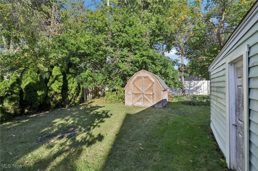 1503 Oakmount Road South Euclid, OH 44121 - Photo 45 of 50 View of grassy yard with a storage shed and view of scattered trees