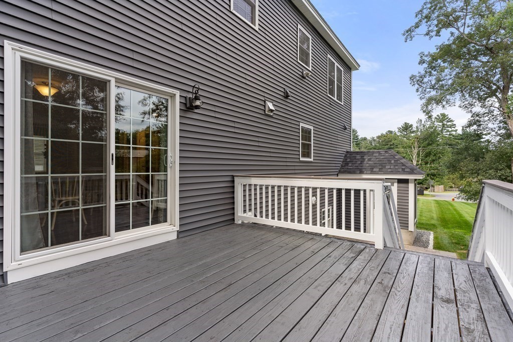 2 Georgianna Road Billerica, MA 01821 - Photo 18 of 41 a view of deck with a large window and wooden floor