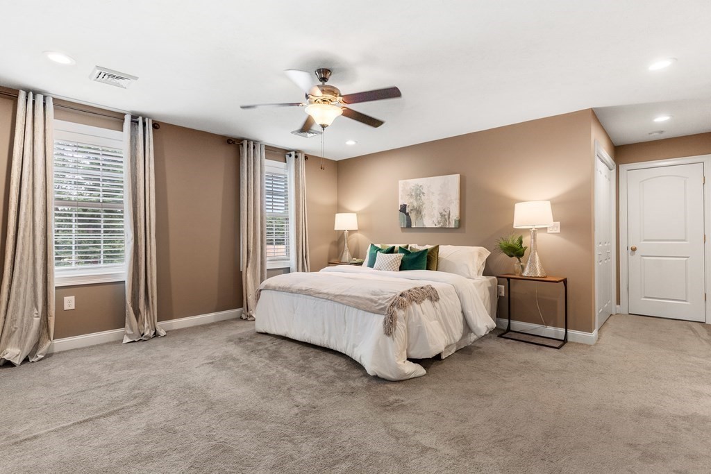 2 Georgianna Road Billerica, MA 01821 - Photo 20 of 41 a spacious bedroom with a bed and a chandelier