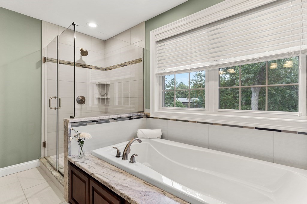 2 Georgianna Road Billerica, MA 01821 - Photo 24 of 41 a bathroom with a granite countertop sink mirror bathtub and shower