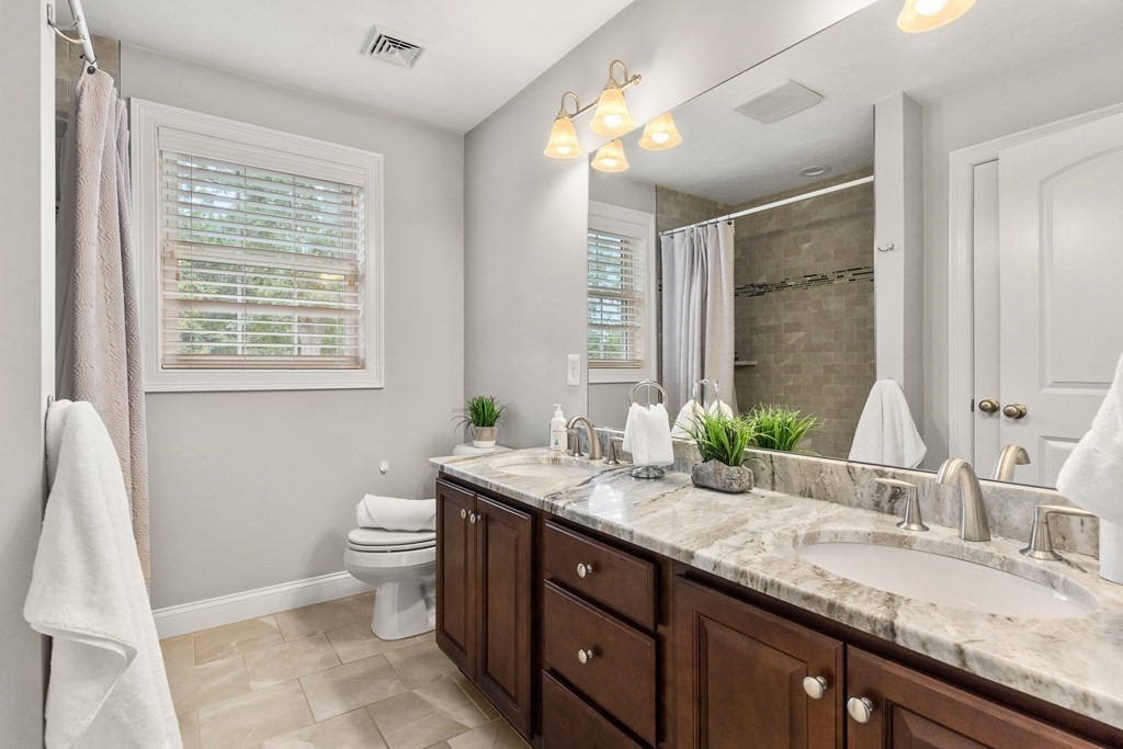 2 Georgianna Road Billerica, MA 01821 - Photo 29 of 41 a bathroom with a granite countertop sink toilet and mirror