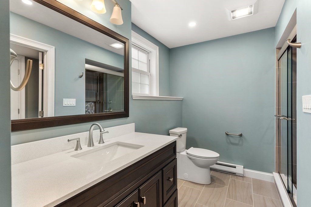2 Georgianna Road Billerica, MA 01821 - Photo 35 of 41 a bathroom with a granite countertop sink toilet and mirror