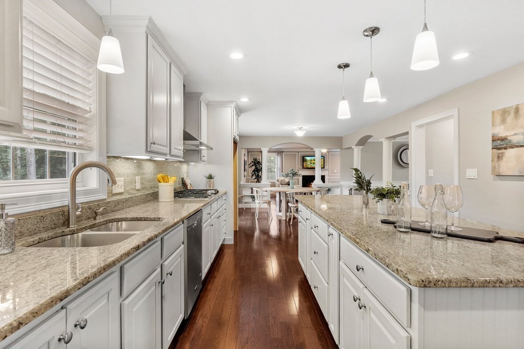 2 Georgianna Road Billerica, MA 01821 - Photo 7 of 41 a large kitchen with granite countertop a large counter top a sink stainless steel appliances and cabinets