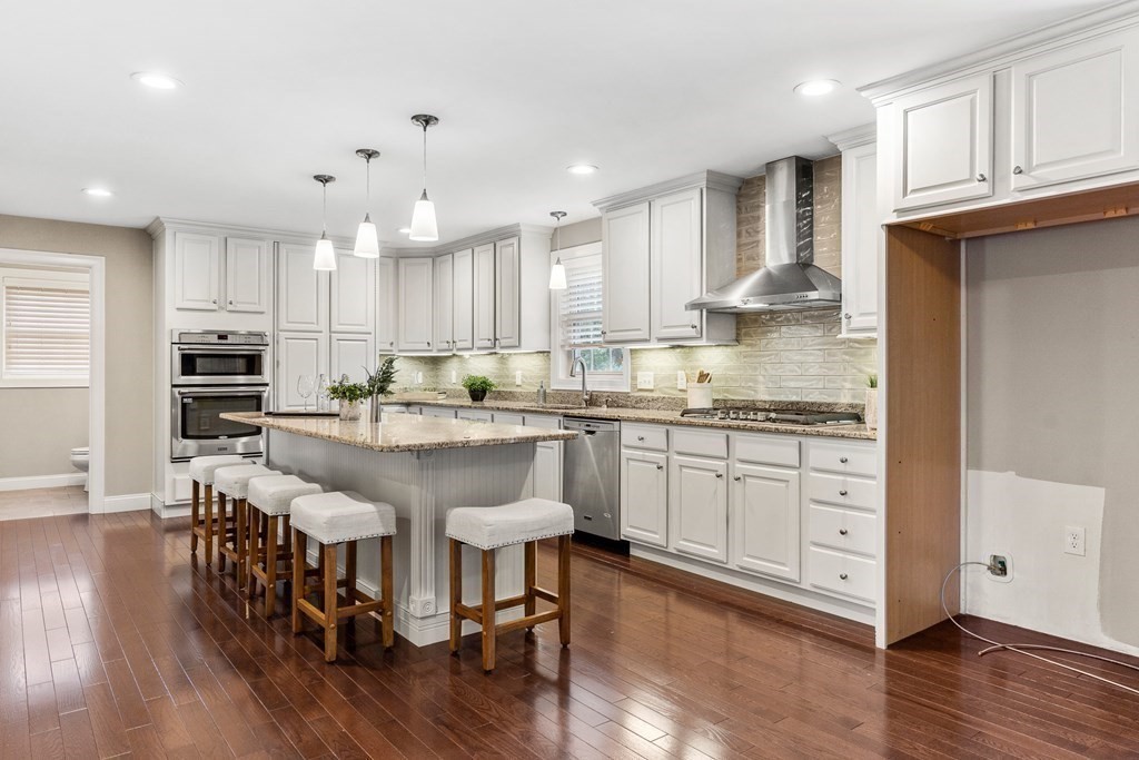 2 Georgianna Road Billerica, MA 01821 - Photo 8 of 41 a kitchen with stainless steel appliances granite countertop a white table chairs and a refrigerator