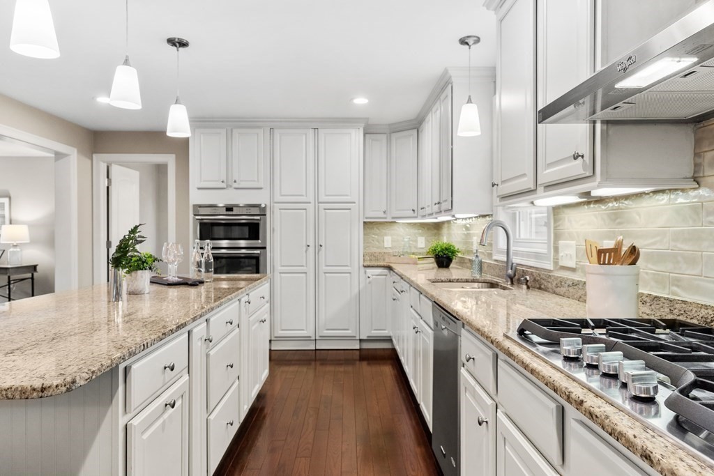 2 Georgianna Road Billerica, MA 01821 - Photo 9 of 41 a kitchen with stainless steel appliances kitchen island granite countertop a sink a stove and a refrigerator