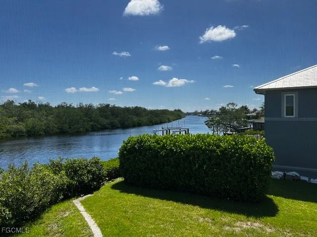a view of a lake with houses in the back