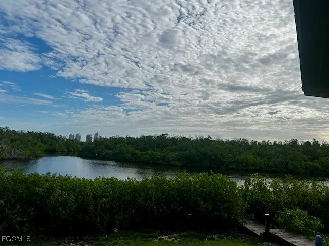 a view of a lake with houses in the back