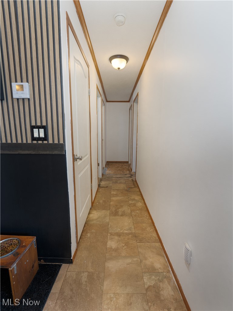 4391 Sandy Lake Road Ravenna, OH 44266 - Photo 23 of 30 Hallway with ornamental molding and wallpapered walls