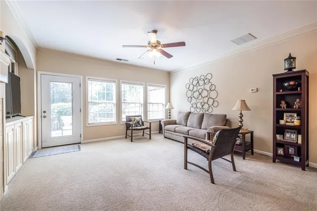 a living room with furniture and a large window