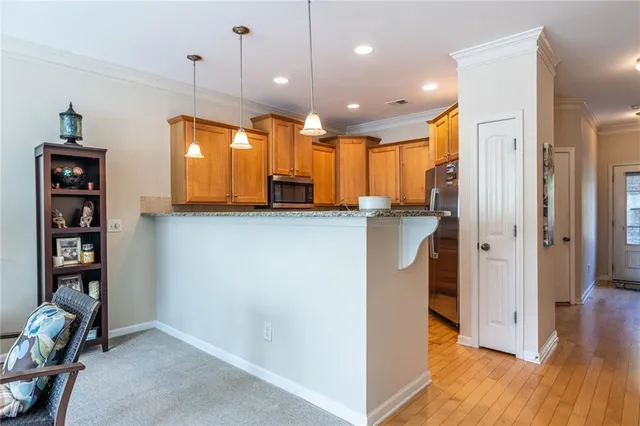 a view of a kitchen with furniture and wooden floor