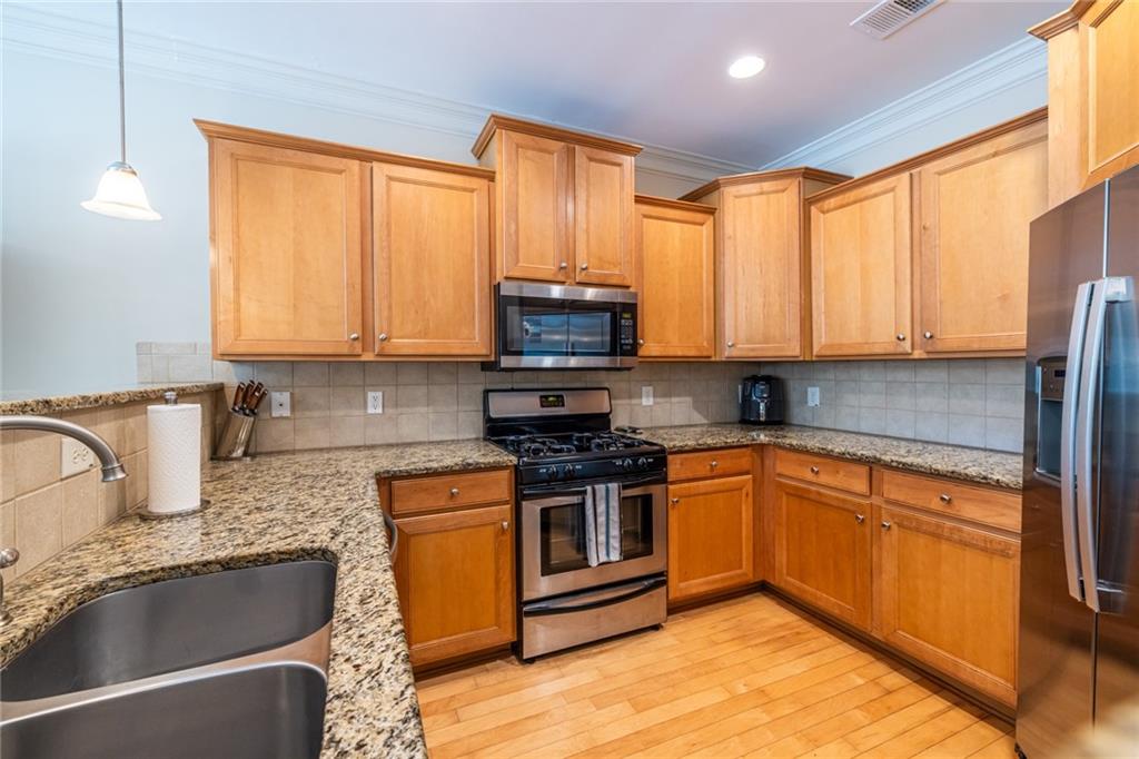 154 Trailside Way Hiram, GA 30141 - Photo 19 of 44 a kitchen with stainless steel appliances granite countertop a stove a sink and a microwave