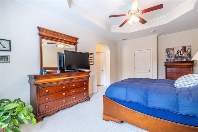 a bedroom with a bed and a television