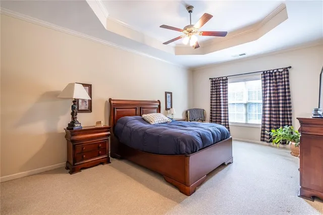 a spacious bedroom with a bed and a chandelier
