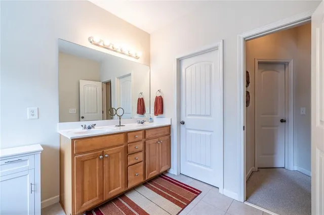 a bathroom with a double vanity sink and a mirror