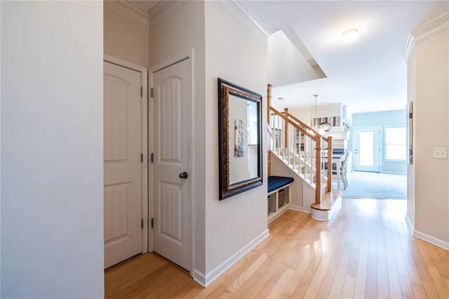 a view of a hallway with wooden floor and stairs