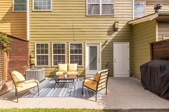 a view of a patio with a table and chairs