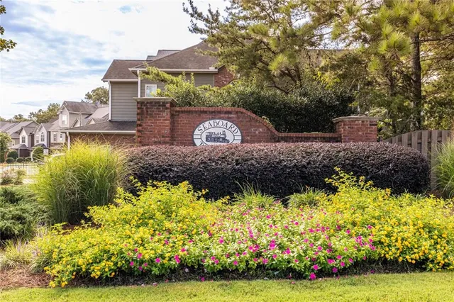 a front view of a house with a yard and fountain