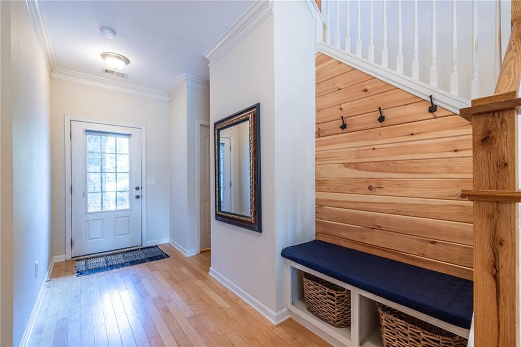 154 Trailside Way Hiram, GA 30141 - Photo 7 of 44 a view of hallway with stairs and wooden floor