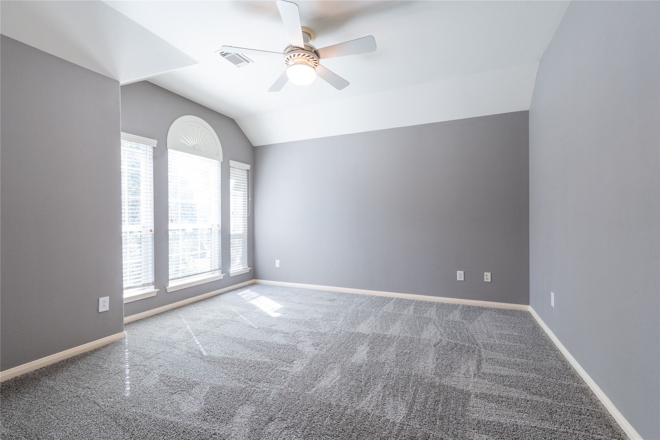 10619 Crownsedge Drive Spring, TX 77379 - Photo 11 of 38 Bright and spacious home office/flex fourth bedroom off of the entry way with fresh gray carpeting, neutral gray walls, and a ceiling fan. Features large windows for ample natural light and a vaulted ceiling for added elegance.