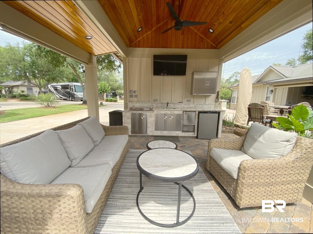 28888 Canal Road, Unit 77 Orange Beach, AL 36561 - Photo 13 of 23 Covered outdoor living area featuring a vaulted wood-paneled ceiling, ceiling fan, and recessed lighting