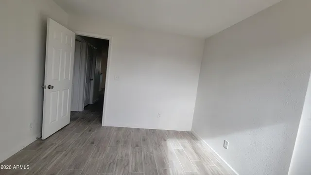 a view of a hallway with wooden floor