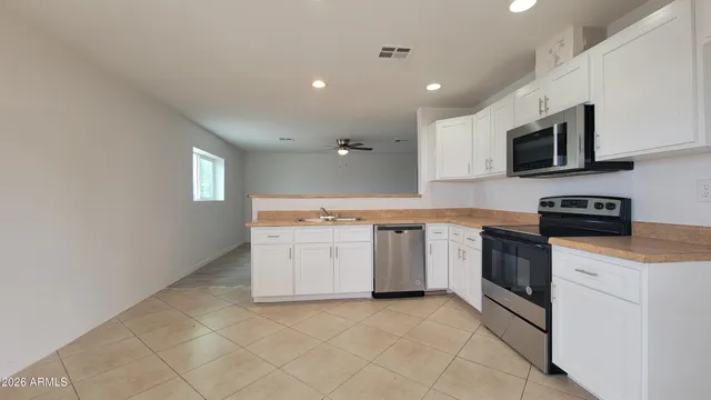 an empty room with wooden floor and a window