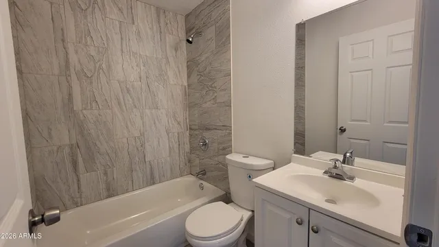 a bathroom with a toilet a sink and shower