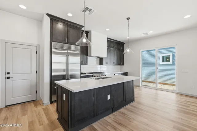 a kitchen with a stove a sink and a refrigerator
