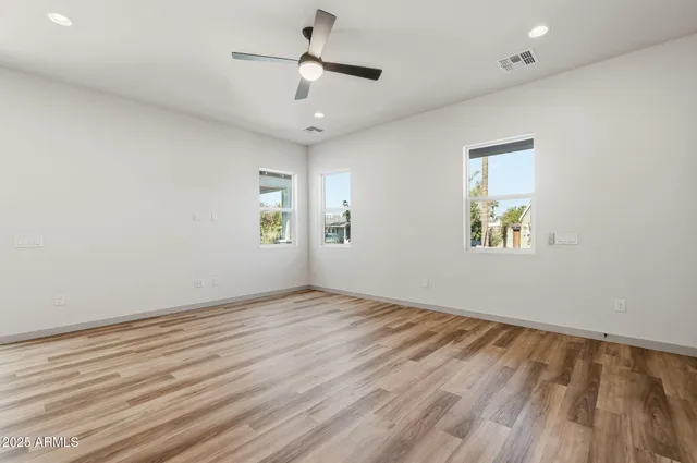 wooden floor in an empty room with a window